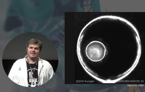 Image of a dividing cell under a microscope; an inset of an educator is to the left.