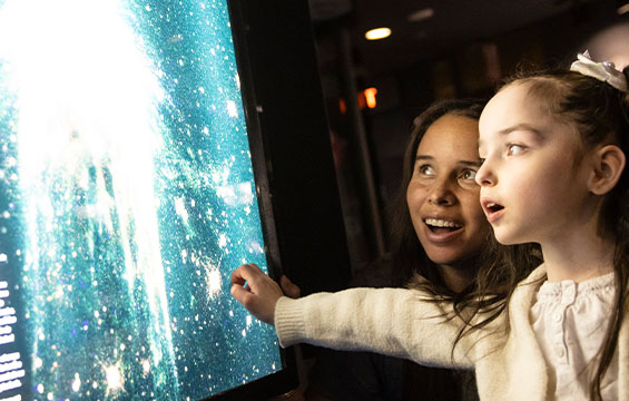 Two people explore the Space Hall.