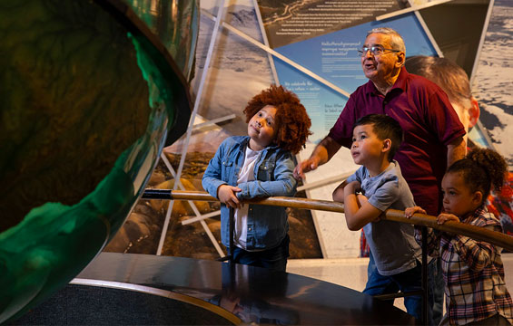 A group of people looking at the giant globe at the Science Centre.