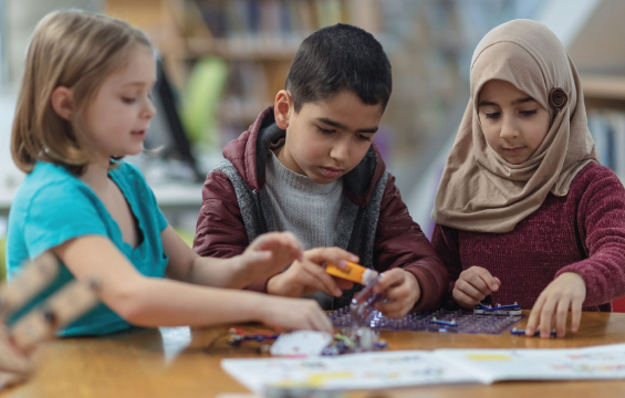 Three children work together on a science project.