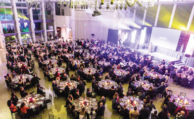 An aerial shot of ball attendees dining in the Great Hall.