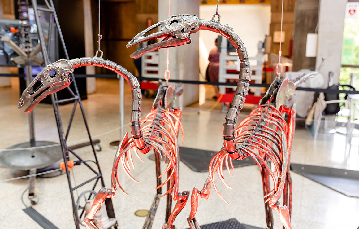 Two metal dinosaur sculptures.