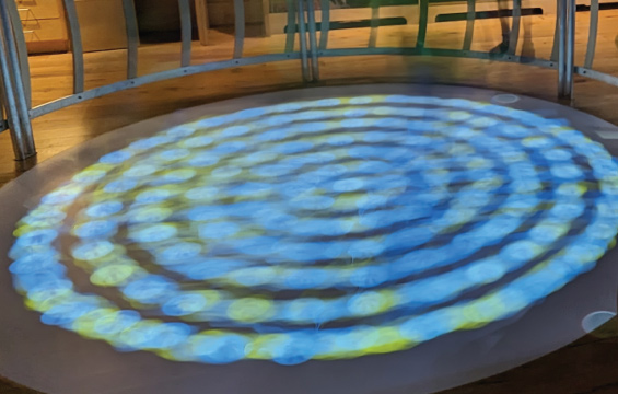 A circular floor projection exhibit.