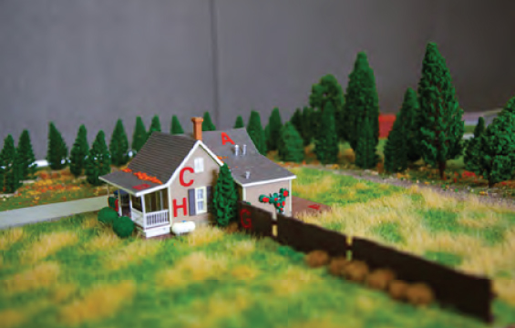 A diorama showing featuring a house, demonstrating wildfire risk.