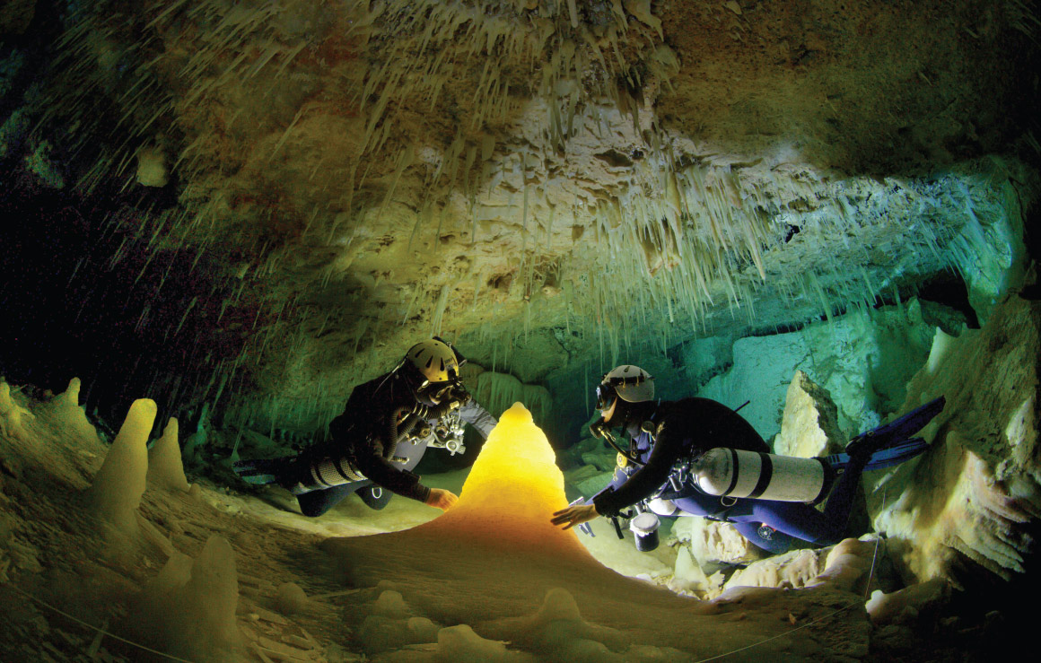 Two divers in an underwater cave.