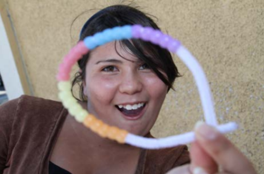 A girl playing with color changing UV beads.