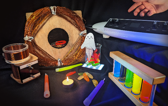 Colourful, glowing objects are laid out on a table as a hand reaches in.
