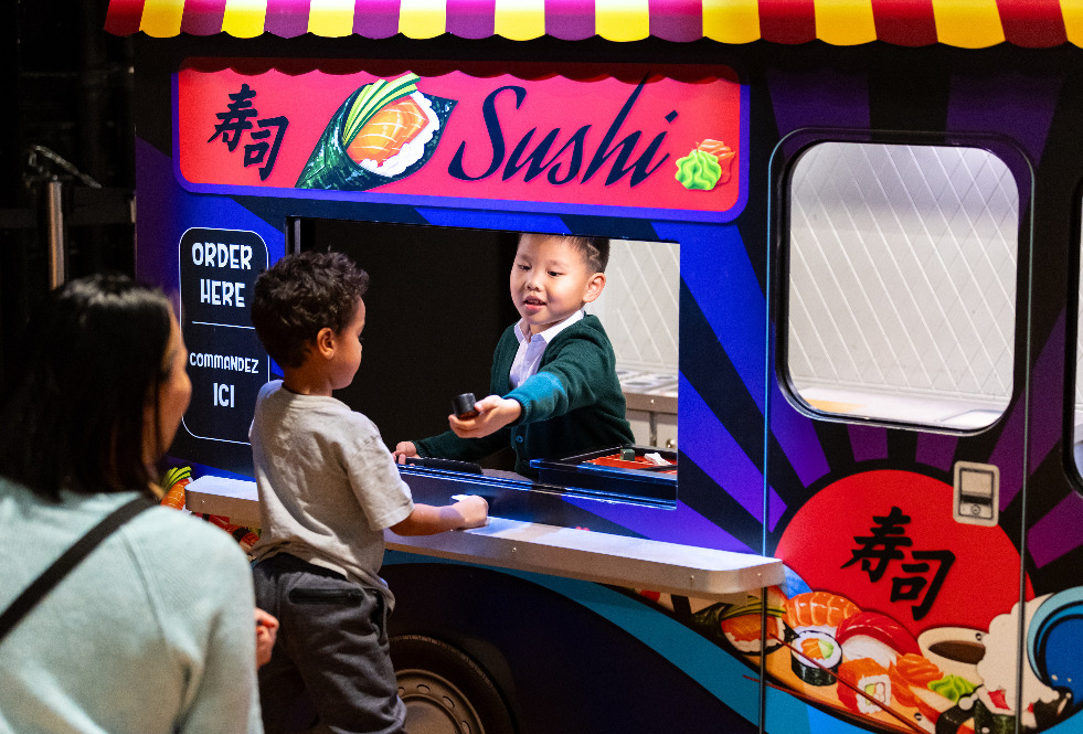 Kids playing at the sushi shop in KidSpark.