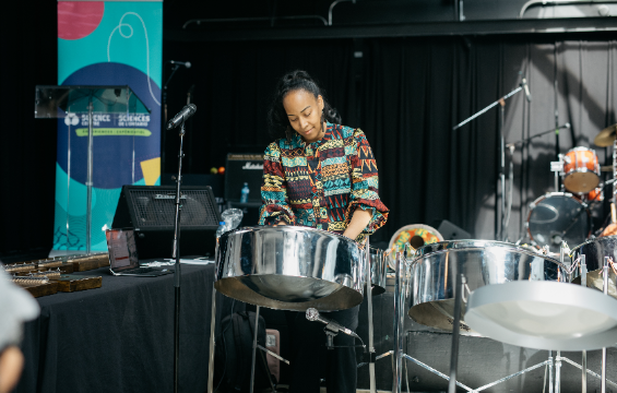A woman plays the steelpan.