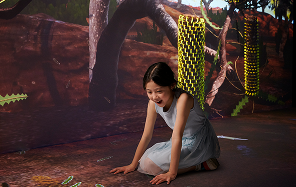 A girl plays in the Earth Matters Exhibit.