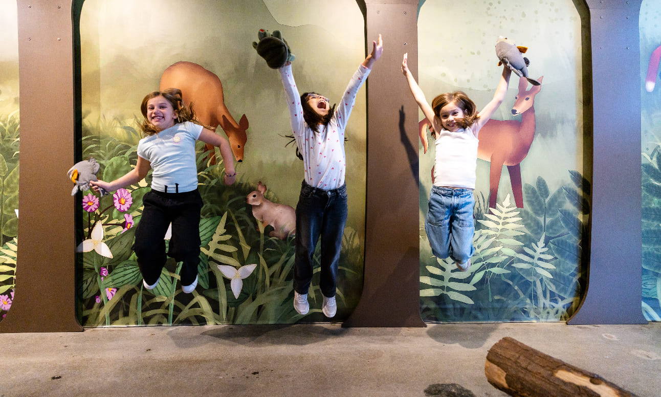 Three girls jumping and having fun at the harbourfront centre.