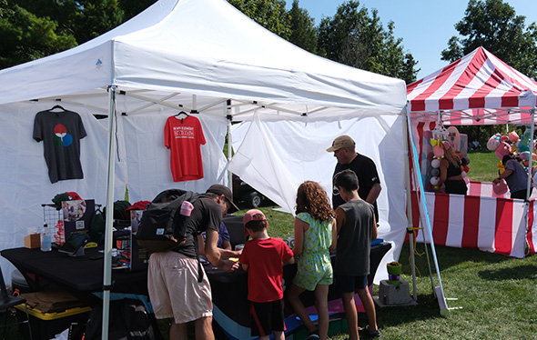 A family looks at the Ontario Science Centre event booth.