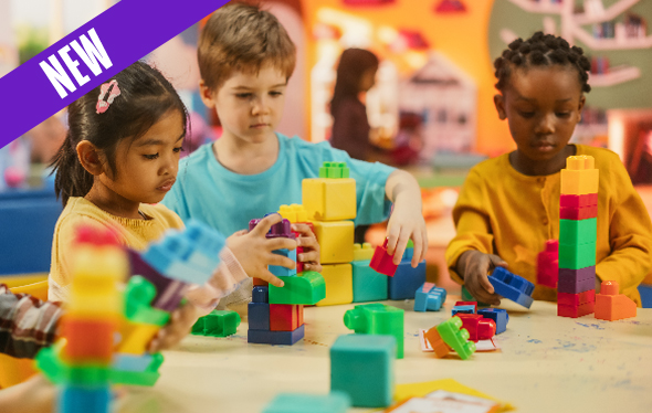 Three kids play with building blocks.