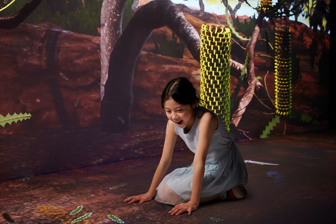 A girl plays in the Earth Matters exhibit