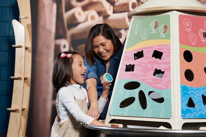 A mother and child play in the Earth Matters exhibit