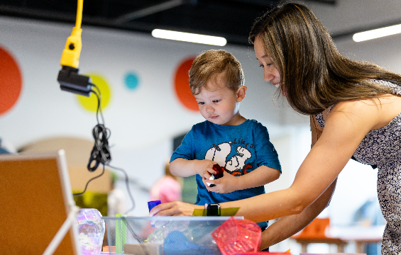 A boy and his mother playing at the Innovation Station.