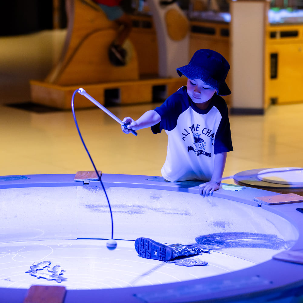A boy using a fishing rod.