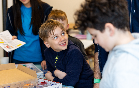 A boy performing an electronic science experiment.