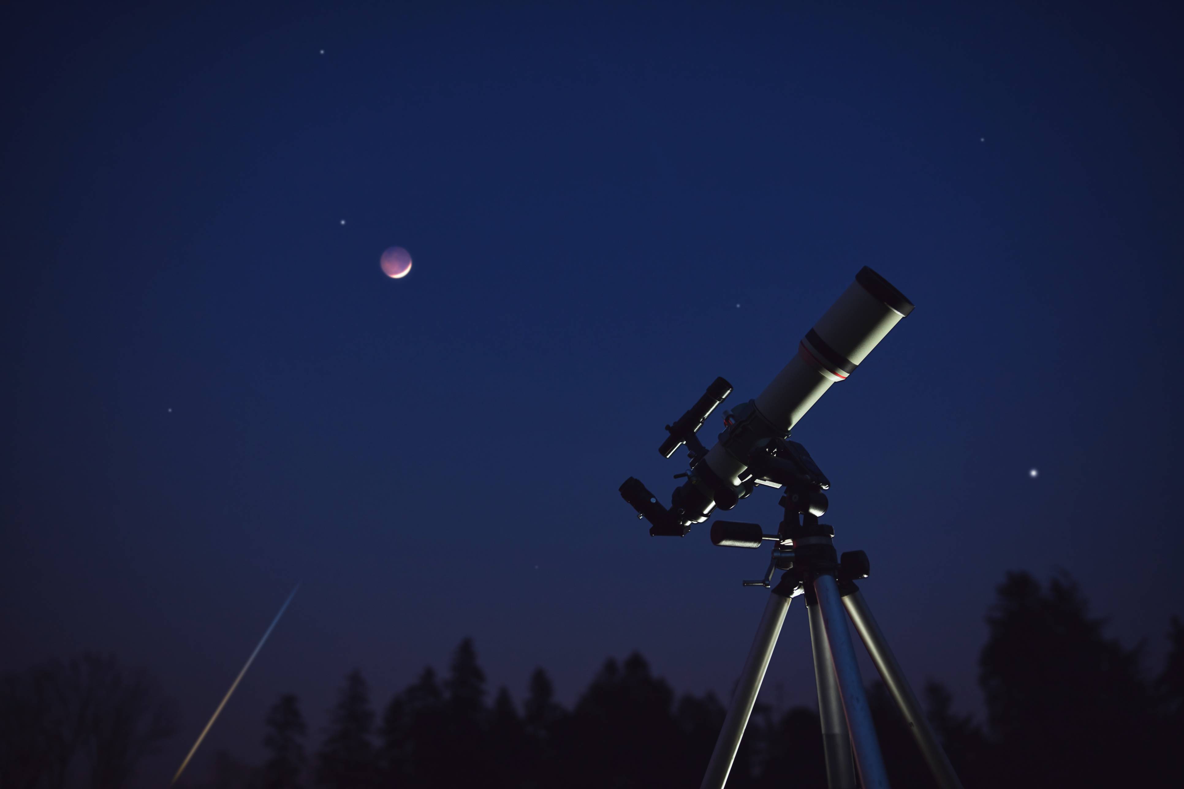 A telescope looks up at the night sky