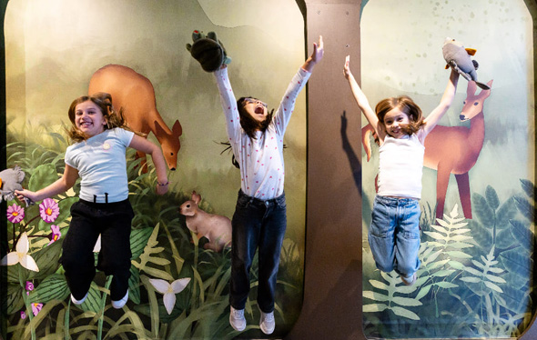 Three girls jumping and having fun at the harbourfront centre.