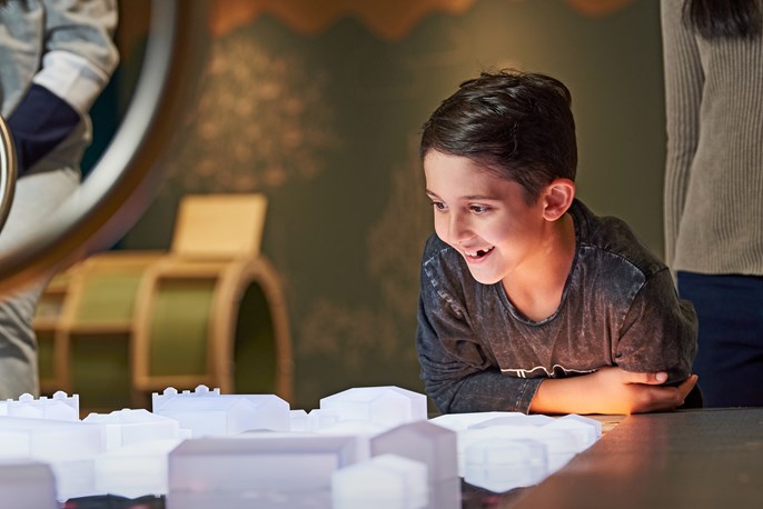 A boy looks happy in the earth matters exhibit